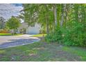 A beautifully landscaped home on a corner lot boasts mature trees and an attached two-car garage at 110 Salinas Ct, Summerville, SC 29483