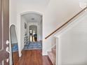 Inviting entryway boasts hardwood floors, an elegant archway, and stylish decor with a staircase on the right at 111 Gavins Way, Goose Creek, SC 29445