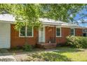 Close up of brick and siding home featuring a charming front porch and meticulously maintained landscaping at 113 Owens Cir, Summerville, SC 29483