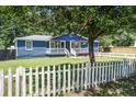 Charming blue home with a white picket fence and front porch at 116 Cone Ln, Summerville, SC 29483