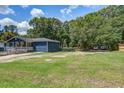 Spacious yard with a blue house, large trees, and parking space at 116 Cone Ln, Summerville, SC 29483