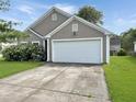 Charming home featuring a two-car garage and a lovely, green lawn at 120 Larkspur Dr, Goose Creek, SC 29445