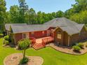 Aerial view of brick home with spacious backyard, wood deck, and well-maintained lawn at 121 Arrowridge Ct, Summerville, SC 29485