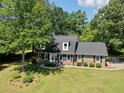 An aerial view of the property showcasing a two-story home, mature trees, and a spacious lawn at 122 Mellard Dr, Goose Creek, SC 29445