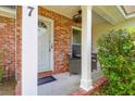 Inviting front porch with brick accents, seating area, and stylish front door at 1287 Chatfield St, Mount Pleasant, SC 29464