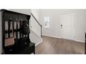 Bright foyer with hardwood flooring, staircase, hall tree, and front door at 130 Spotted Way, Summerville, SC 29485