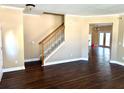 Bright living room featuring hardwood floors and staircase with wooden handrail at 1333 Song Sparrow Way, Hanahan, SC 29410