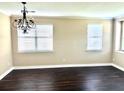 Spacious living room featuring hardwood floors, white trim and two windows with wooden blinds at 1333 Song Sparrow Way, Hanahan, SC 29410