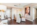 Dining area with modern lighting, a glass table, and an elegant Personal painting on the wall at 14 Lockwood Dr # 4C, Charleston, SC 29401