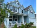 Charming two-story home showcasing a welcoming front porch and well-maintained landscaping, exuding curb appeal at 141 Cherry Grove Dr, Summerville, SC 29483