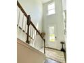 Bright foyer boasting a high ceiling, staircase with wood railing, and a stylish rug, creating a grand entrance at 141 Cherry Grove Dr, Summerville, SC 29483