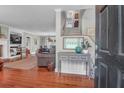 Warm foyer with hardwood floors, leading to a staircase and a living room with a fireplace at 1521 Wren Ave, Mount Pleasant, SC 29464