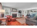 Cozy living room with hardwood floors, fireplace, built-in shelving, and comfortable seating at 1521 Wren Ave, Mount Pleasant, SC 29464