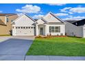 Charming single-story home with a two-car garage, manicured lawn, and classic white siding at 1671 Grange Cir, Summerville, SC 29486