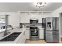 Modern kitchen with stainless steel appliances, white cabinets, and a stylish backsplash, ideal for cooking enthusiasts at 172 Ashton Dr, Goose Creek, SC 29445