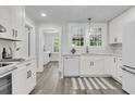 Bright, eat-in kitchen with white cabinets, quartz countertops, and stainless steel appliances at 1730 Harrison Ave, Charleston, SC 29407