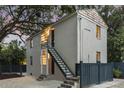 Exterior evening view featuring stucco, stairs, updated windows, lighting, and manicured landscaping around the perimeter at 19 Smith St # C, Charleston, SC 29401