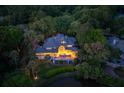 Picturesque backyard with spacious deck overlooking the pond and lush greenery at twilight at 200 Belted Kingfisher Rd, Kiawah Island, SC 29455