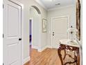 Hallway featuring hard surface floors and a view into a bedroom through an arched doorway at 2008 Welsh Pony Dr, Mount Pleasant, SC 29429