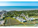 Expansive aerial view of a coastal community with marshland and a beautiful beach at 204 Michigan Ave B3 # 16, Folly Beach, SC 29439