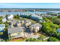 Aerial view of a waterfront community with colorful homes, a marina, and lush landscaping at 204 Michigan Ave B3 # 16, Folly Beach, SC 29439