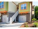 A home's exterior featuring stairs leading to the entrance, and a two-car garage at 204 Michigan Ave B3 # 16, Folly Beach, SC 29439