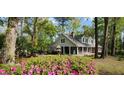 Inviting exterior of home surrounded by lush landscaping, showcasing its serene setting and charming curb appeal at 206 Chaussee Blvd, Summerville, SC 29483