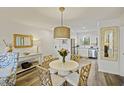 Bright dining area featuring a round table, decorative lighting, and an open view into the kitchen at 2063 Long Bend Dr, Seabrook Island, SC 29455