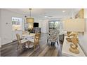 Cozy dining area with a round table, stylish chairs, and a view into the living room and outdoor balcony at 2063 Long Bend Dr, Seabrook Island, SC 29455