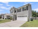 Charming two-story home featuring a two-car garage, well-maintained lawn, and attractive landscaping at 2109 Rowan Rd, Johns Island, SC 29455