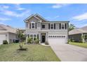 Charming two-story home featuring a two-car garage, well-maintained lawn, and attractive landscaping at 2109 Rowan Rd, Johns Island, SC 29455