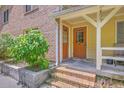 Apartment building's entrance showcases a brick facade, a charming covered porch, and brick steps at 2150 Spoleto Ln # H2, North Charleston, SC 29406