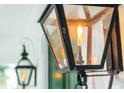 Close-up of a gas-powered outdoor lamp on the front porch with a flame burning at 2431 Settlers St, Charleston, SC 29492