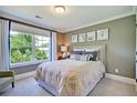 Cozy bedroom with a large window providing ample natural light, complemented by neutral tones and stylish decor at 2476 Grange Cir, Summerville, SC 29486