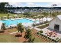 Community pool area with plenty of lounge chairs and a fire pit with Adirondack chairs at 262 Great Lawn Dr, Summerville, SC 29486