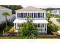 Inviting two-story home with a covered porch and classic black shutters in a peaceful neighborhood setting at 262 Great Lawn Dr, Summerville, SC 29486