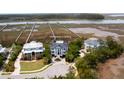 An aerial view of a neighborhood and waterfront featuring beautiful homes with stunning architecture and lush landscaping at 2705 Parkers Landing Rd, Mount Pleasant, SC 29466