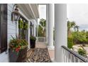 Charming front porch featuring columns, black lanterns, a welcome mat, and potted flowers at 2705 Parkers Landing Rd, Mount Pleasant, SC 29466