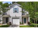 Gray townhouse featuring a one-car garage and well-manicured front lawn at 271 Jackson St, Goose Creek, SC 29445