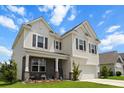 Charming two-story home features a welcoming front porch, attached garage, and classic curb appeal at 2746 Sunrose Ln, Johns Island, SC 29455