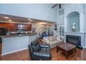 Open-concept living room with hardwood floors, fireplace, and eat-in kitchen at 3031 Ellington Dr, Summerville, SC 29485