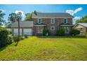 Large backyard featuring a detached garage with a basketball hoop and a well-maintained lawn at 305 Whitewood Ct, Moncks Corner, SC 29461