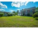 Expansive backyard with lush green grass, mature trees, and a detached garage at 305 Whitewood Ct, Moncks Corner, SC 29461