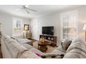 Cozy living room with a large sofa, TV, windows, and neutral decor for a relaxing atmosphere at 34 Dereef Ct, Charleston, SC 29403