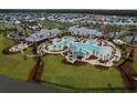 Aerial view of a community pool, water slide, palm trees and amenity center at 410 Eliston St, Summerville, SC 29486