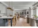 Open-concept living space with kitchen island seating, a comfortable couch, and a cozy fireplace at 507 Mccants Dr, Mount Pleasant, SC 29464