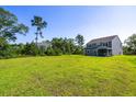 Expansive backyard with lush green grass and privacy provided by mature trees at 5115 Cranesbill Way, Johns Island, SC 29455
