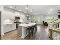 Bright open kitchen featuring a large island, stainless steel appliances, and modern pendant lighting at 5115 Cranesbill Way, Johns Island, SC 29455