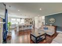 Open-concept living room flowing into the kitchen, with hardwood floors and stylish decor at 5525 Alpine Dr, Summerville, SC 29483