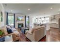 Spacious living room featuring a fireplace, hardwood floors, and an open layout to the kitchen at 5525 Alpine Dr, Summerville, SC 29483
